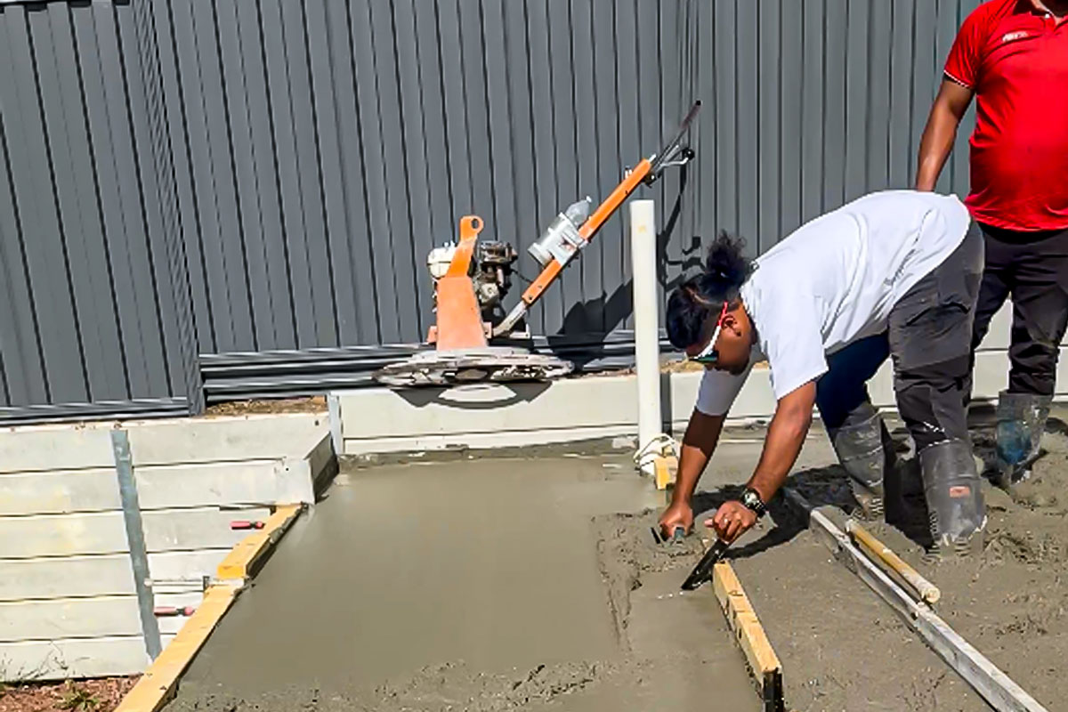 Concrete pour on foundation day with services set into the slab — build sequence reference