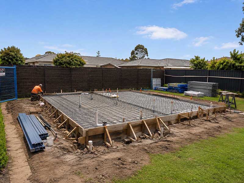 Steel-reinforced slab foundation ready for concrete pour — build sequence reference