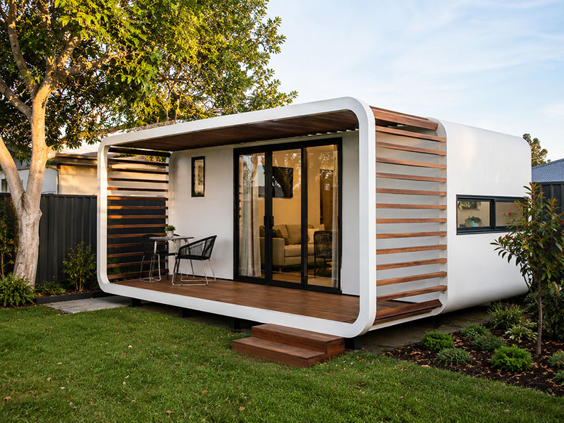 MEG granny flat design concept — curved white shell with timber slats